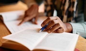 person studying from a book